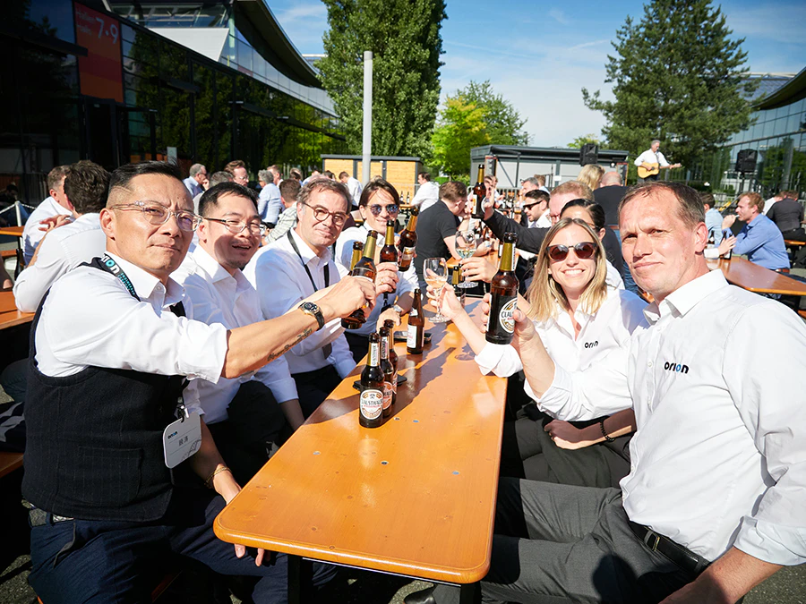 People gathered around a table, drinking beer in a social setting.