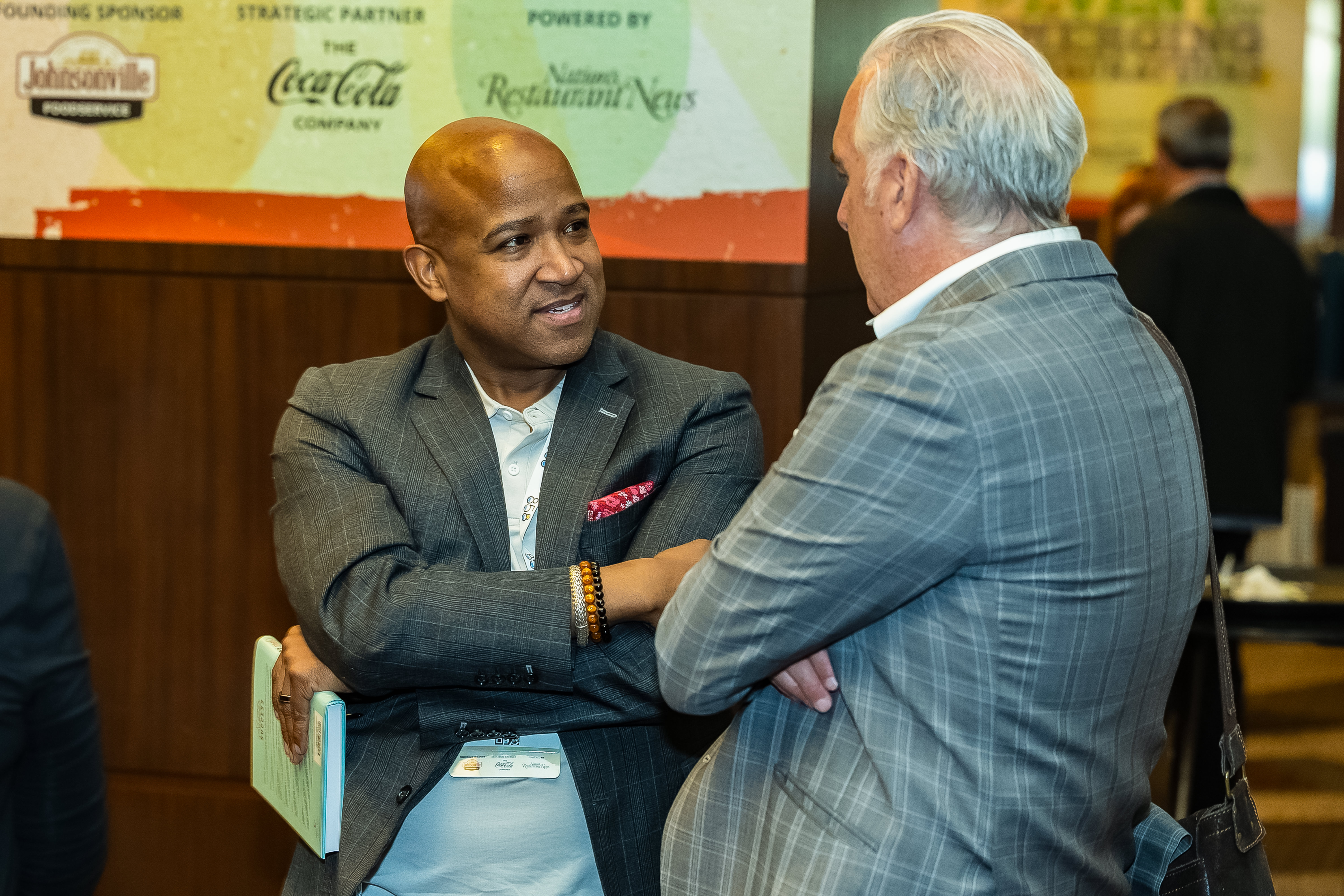 An attendee speaks with Chris Keating at CREATE 2024