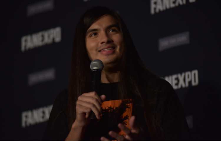 Eduardo Franco holding a microphone, smiling