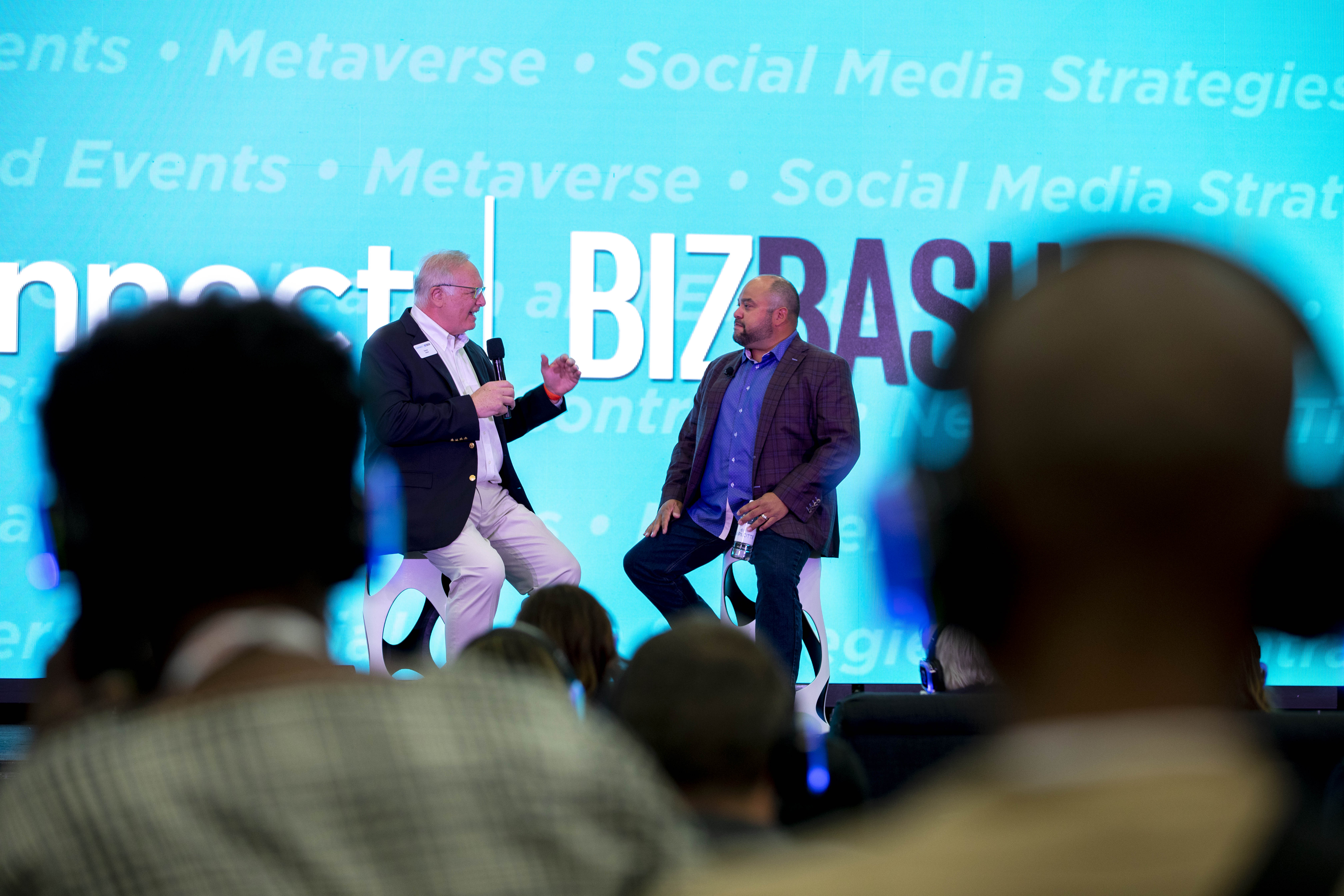 Two men sitting on stage discussing the event industry