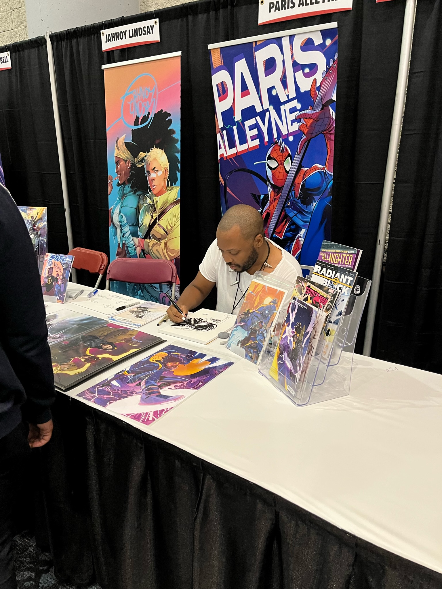 COMIC ARTIST AT THEIR BOOTH