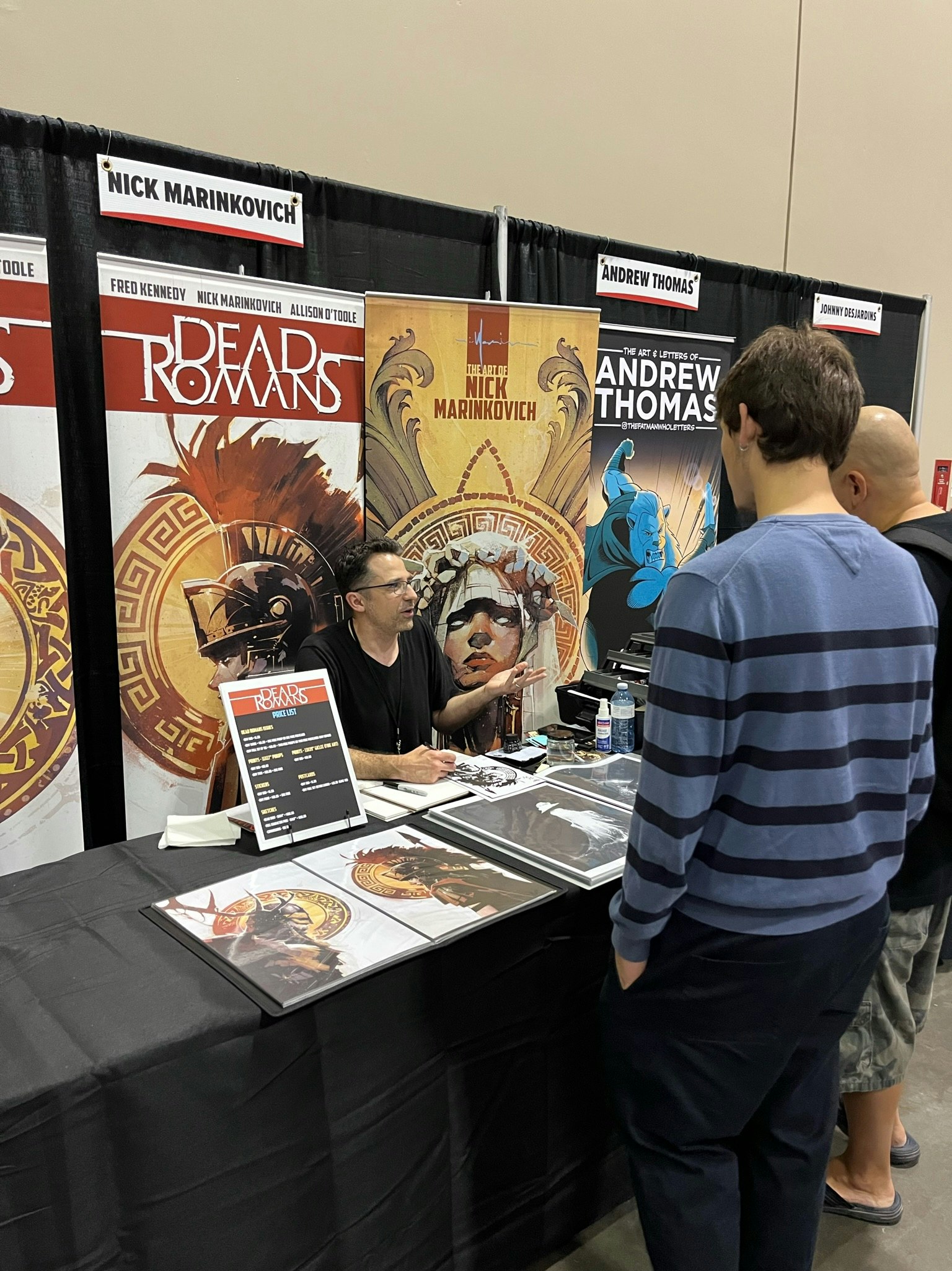 VENDOR TALKS TO FAN AT BOOTH