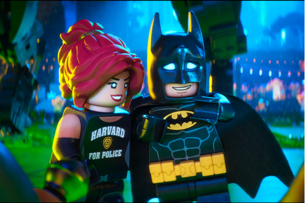 Lego Barbara Gorden in her Harvard for Police shirt standing next to Batman as reporters try to interview them.