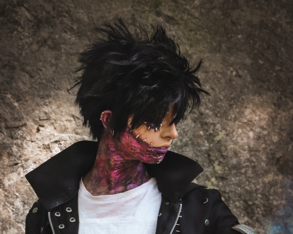 Zoe with a leather jacket, white shirt, black wig and fake burned skin.