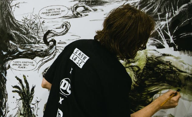 A comic artist works on their artwork at FAN EXPO Canada