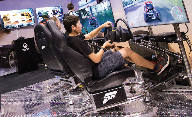 A fan plays a driving simulation game at FAN EXPO Canada