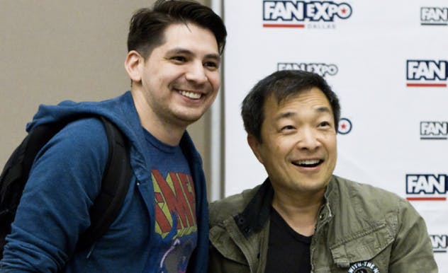 Comic artist Jim Lee posing for Photo Op with fan