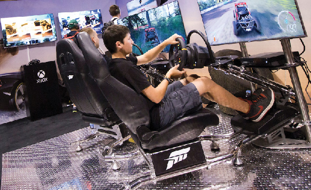 Fans play video games at a gaming booth at MEGACON Orlando