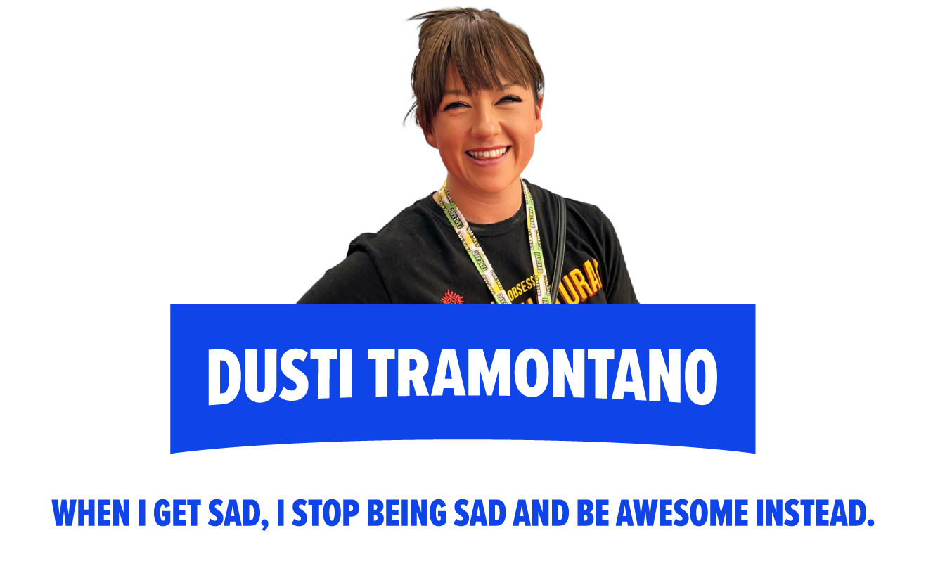 Dusti Tramantano poses with the words "When I get get,  I stop being sad and be awesome instead." written beside her in repeating blue and black text.