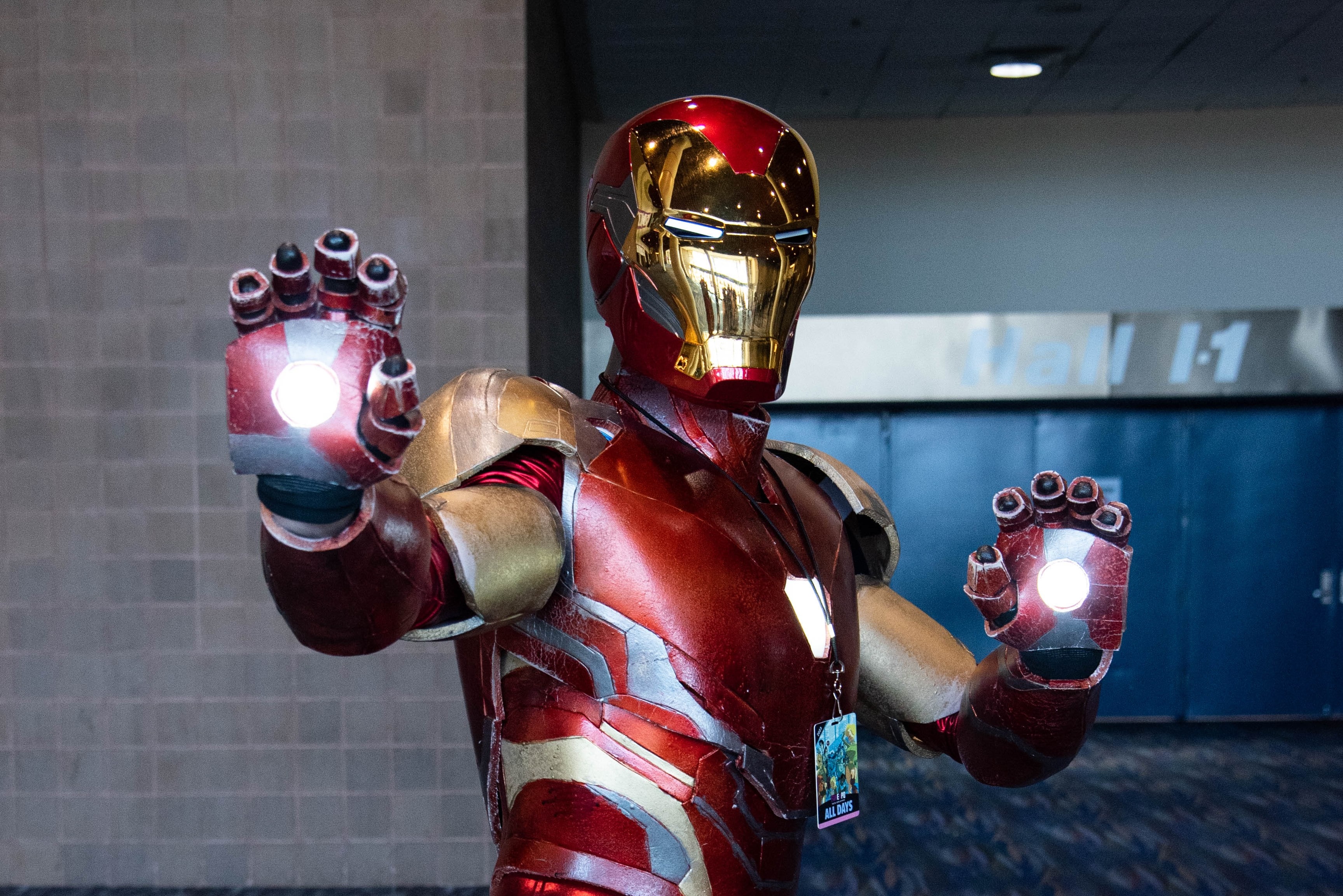 An Iron Man cosplayer posing for the camera, complete with lit up repulsors.