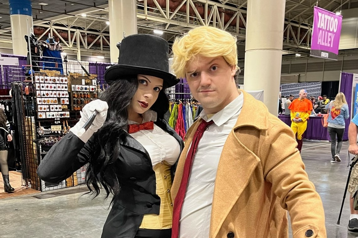 Two cosplayers, Zatanna and Constantine from DC Comics, posing together.