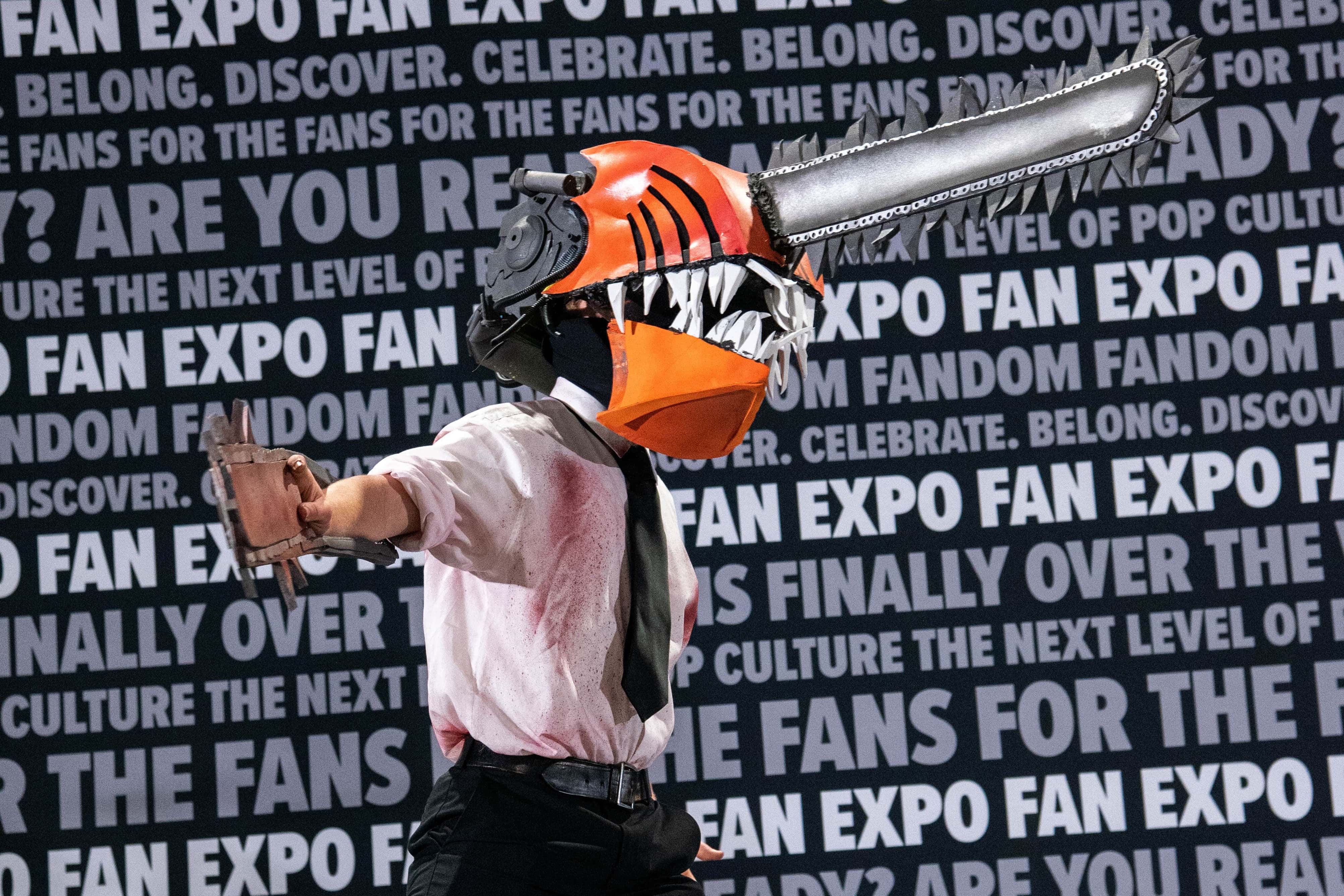 One of the Cosplay Craftsmanship Cup contestants on stage, cosplaying as Chainsaw Man from Chainsaw Man.