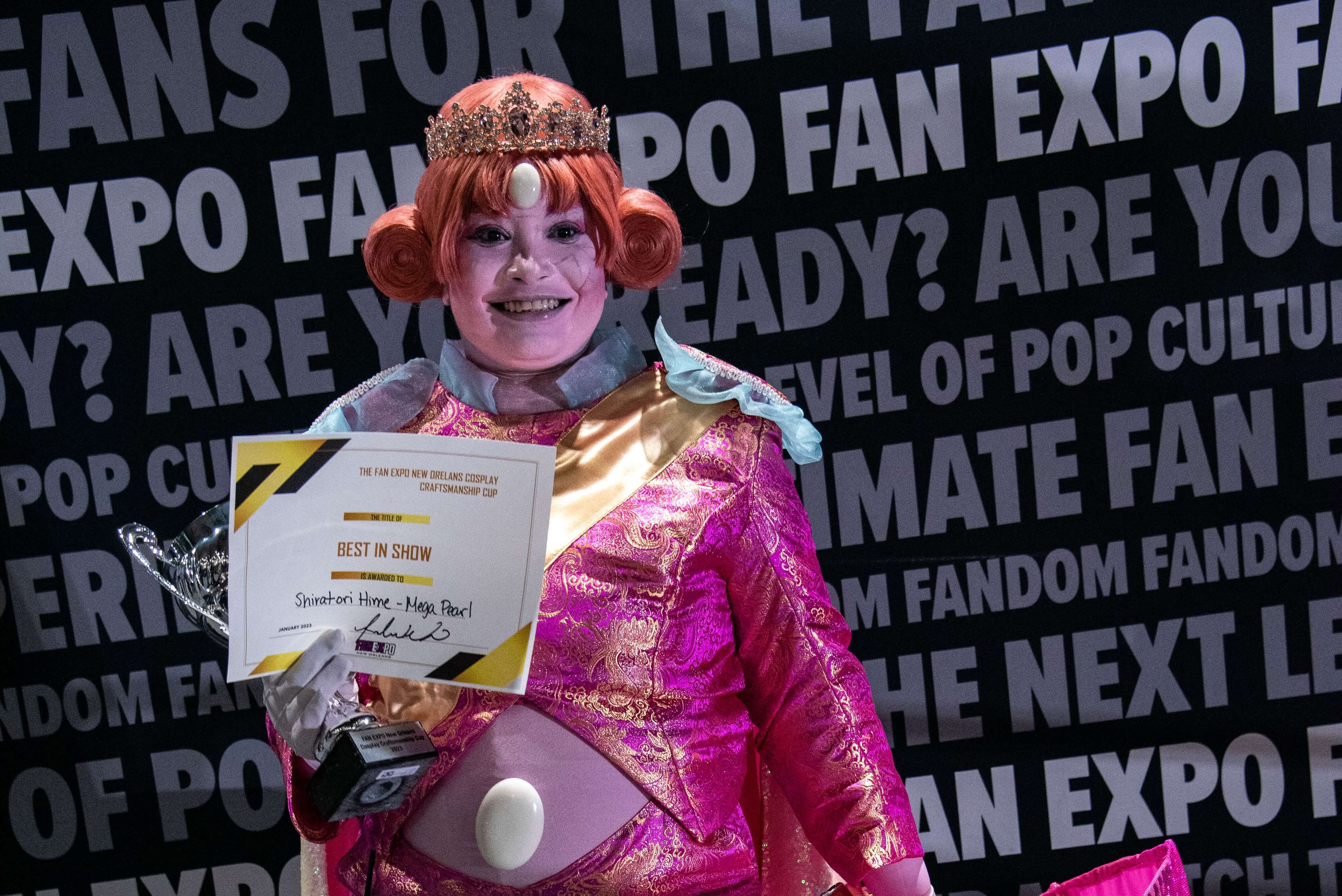 The winner of the FAN EXPO New Orleans 2023 Cosplay Craftsmanship Cup posing for a photo.