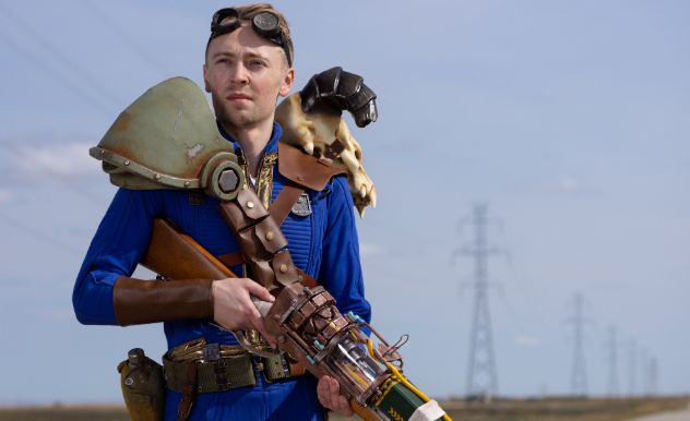 Meciocre Mimicry holding a prop gun and looking off into the distance