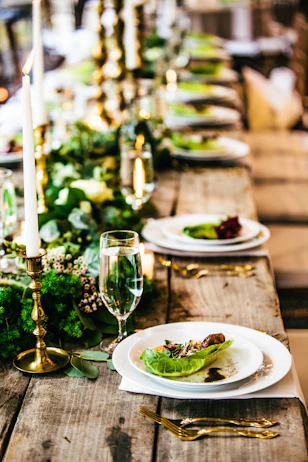 salad plates on a wooden table with candles