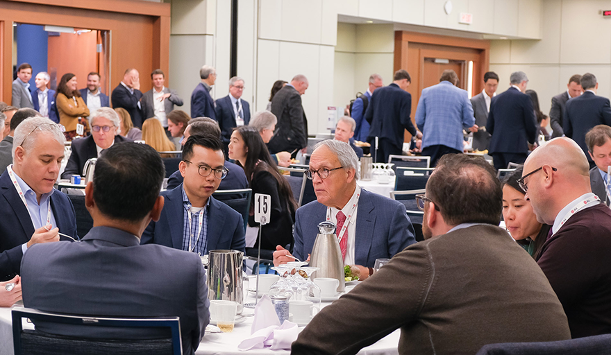 Real estate conference attendees exchanging contact info