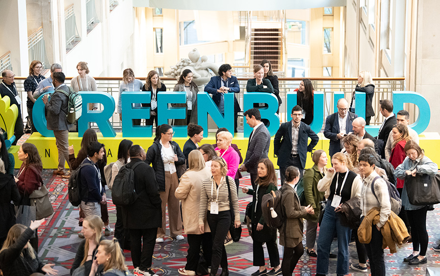 Greenbuild 2024 attendees posing with the Greenbuild sign