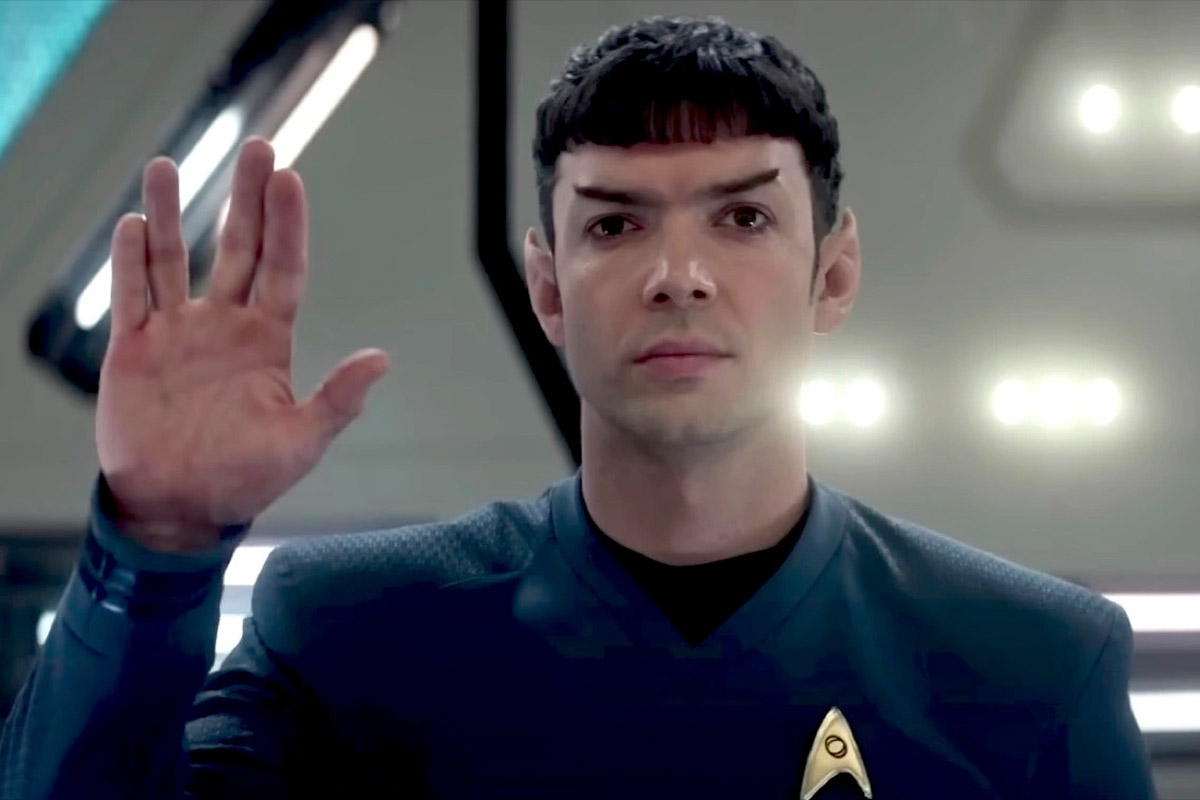Spock stands with the Vulcan salute extended