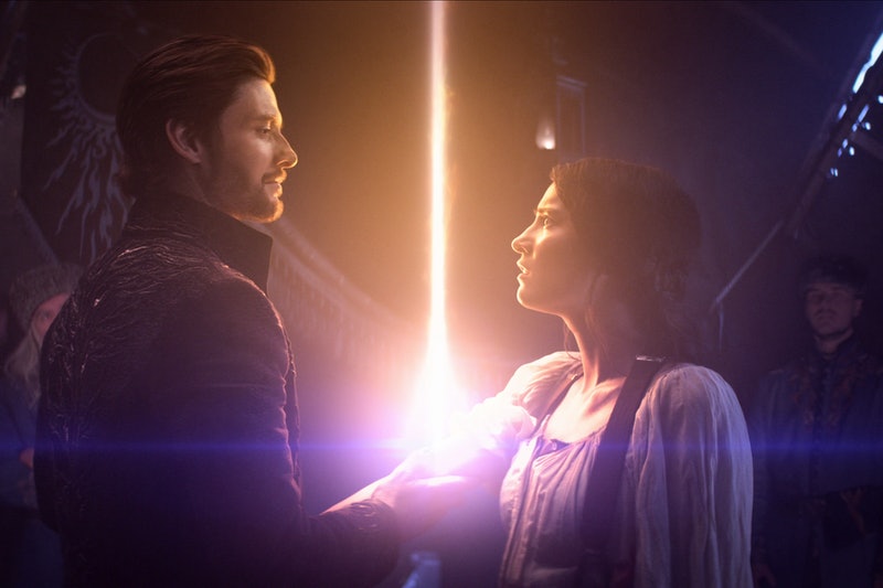 Two characters from the Grishaverse holding each others arms with a glowing beam between them