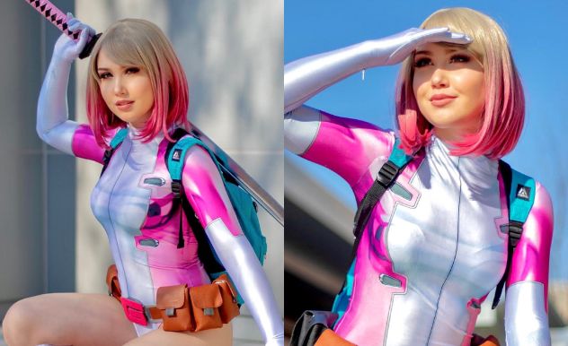 Cosplayer poses in a pink and white one-piece. She has a brown tool belt around her waist and is holding a pink and black sword behind her back.