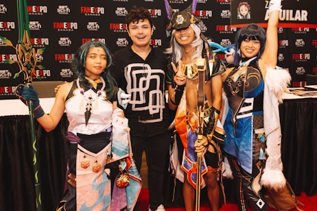 Zach Aguilar posing with fans in cosplay