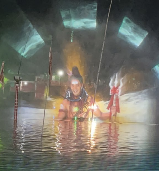 Projection of an indigenous person displayed on a pool and wall