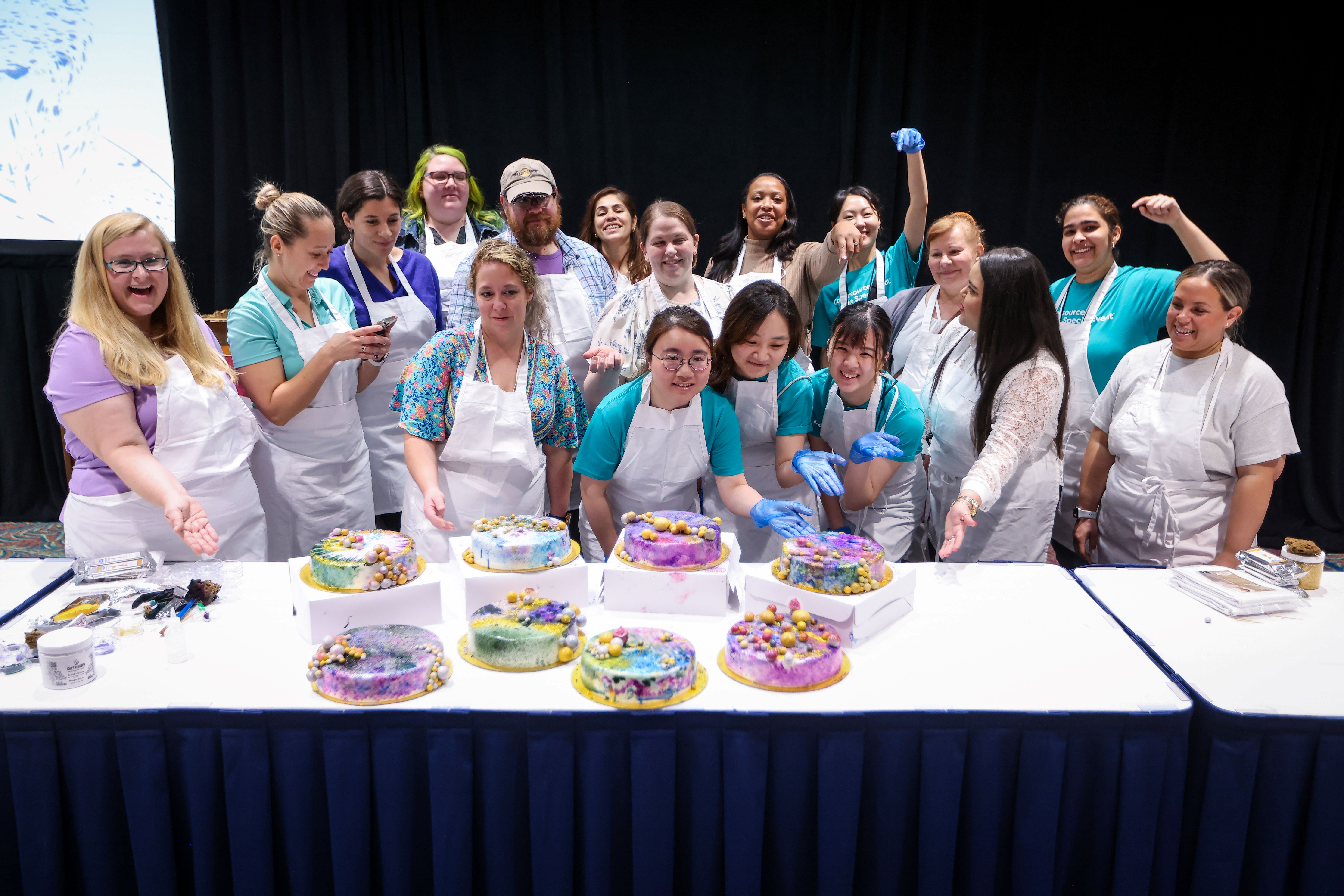 A group of people preparing wedding cakes