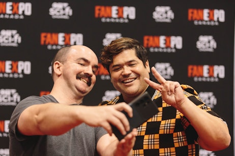 Harvey Guillen taking a selfie with a fan
