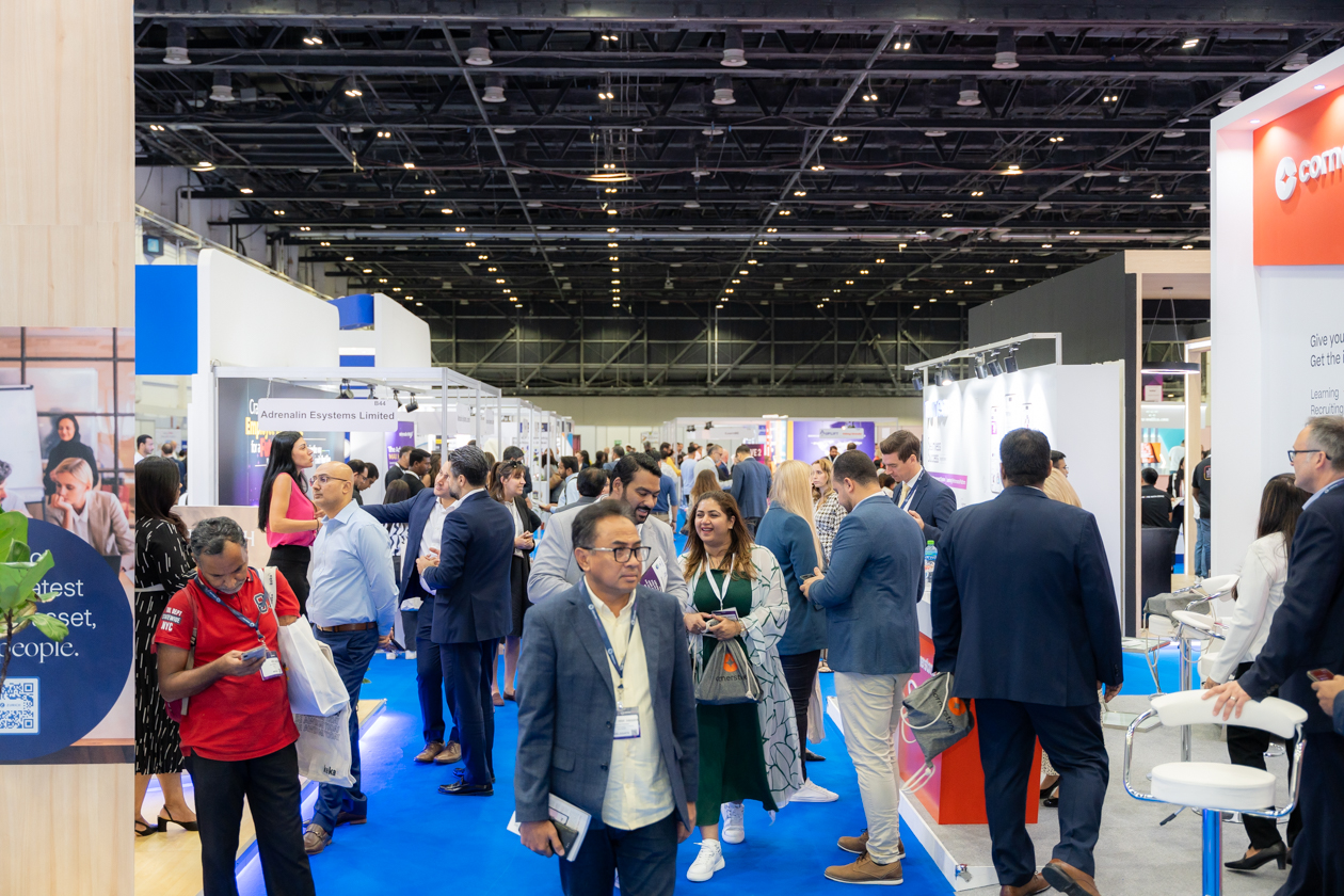 Professionals networking at HRSE Summit with various booths