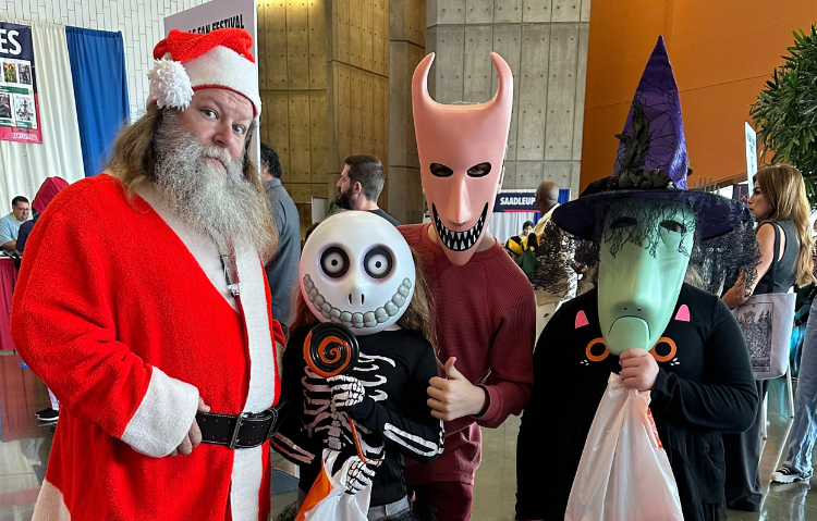 Group of cosplayers dressed as Santa Clause and Lock, Shock, and Barrel from The Nightmare Before Christmas