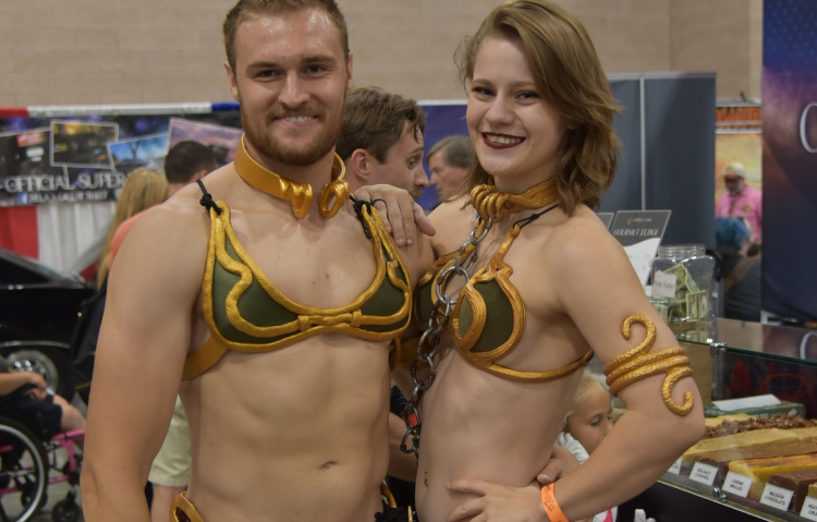 A man and a woman dressed as slave Princess Leia from Star Wars