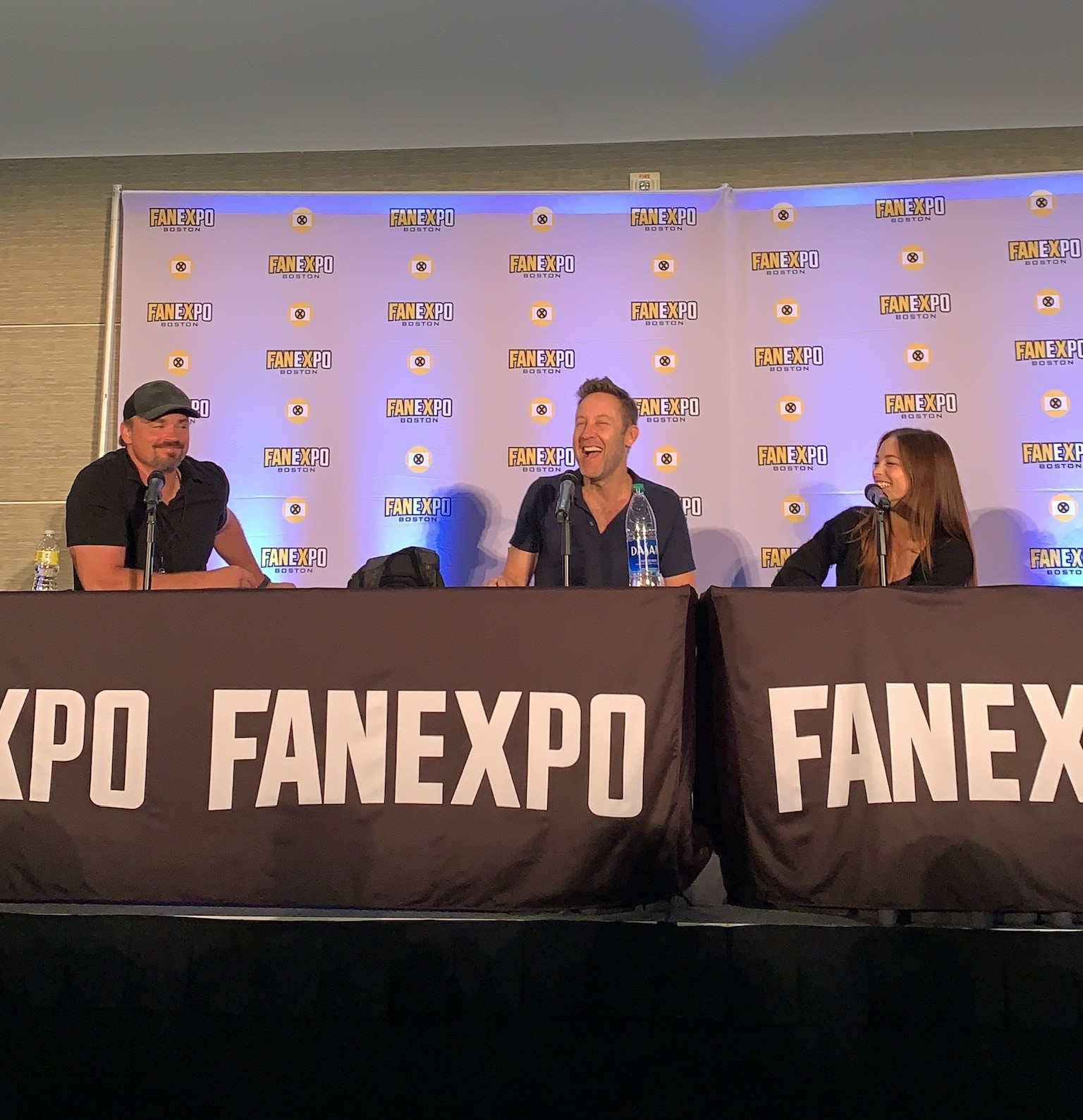 The cast of Smallville at their panel together. From left to right: Tom Welling, Michael Rosenbaum, and Kristen Kreuk.