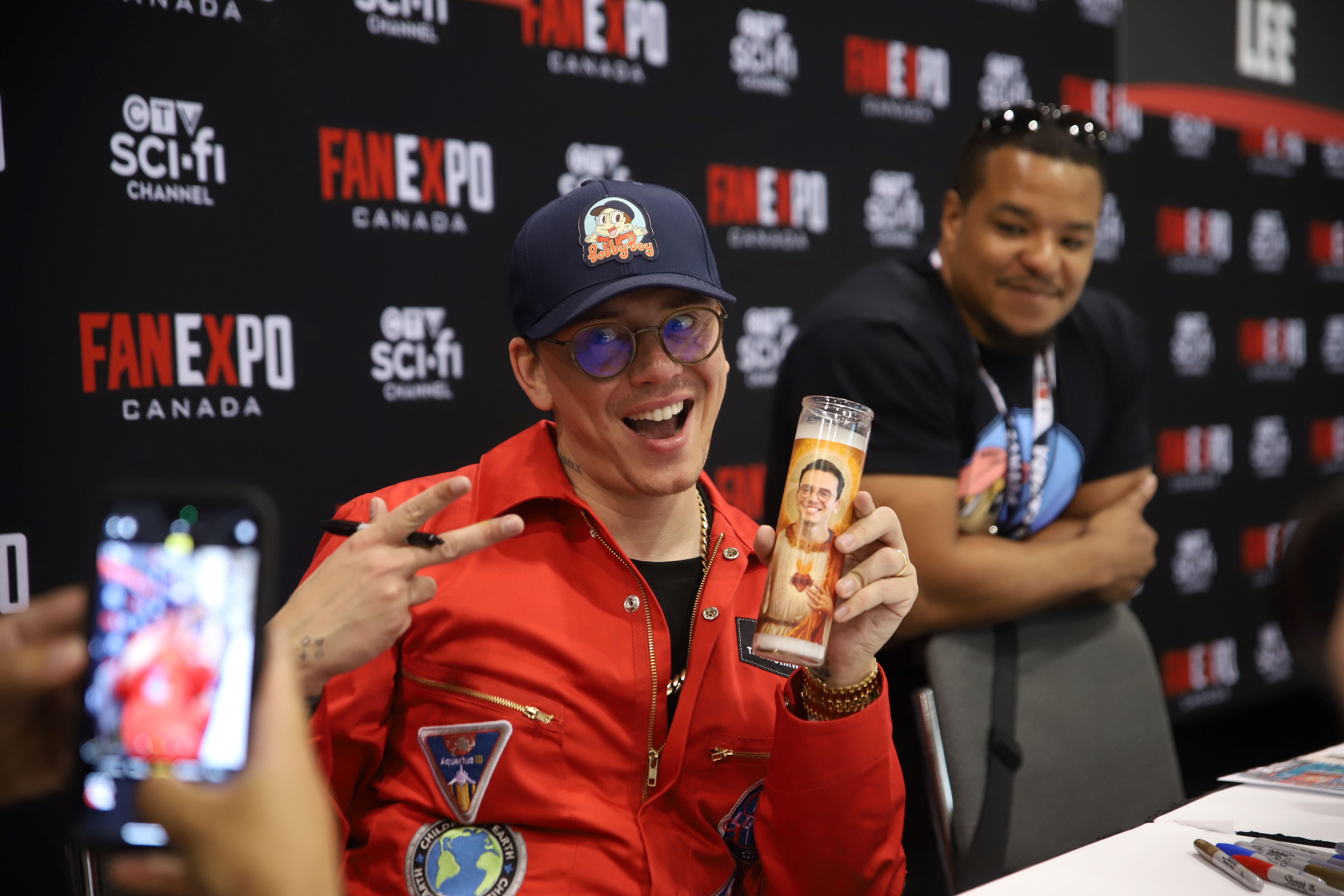 LOGIC POSES WITH A PRAYER CANDLE