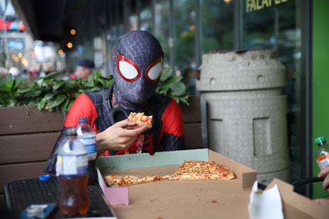 Spider-Man eating pizza