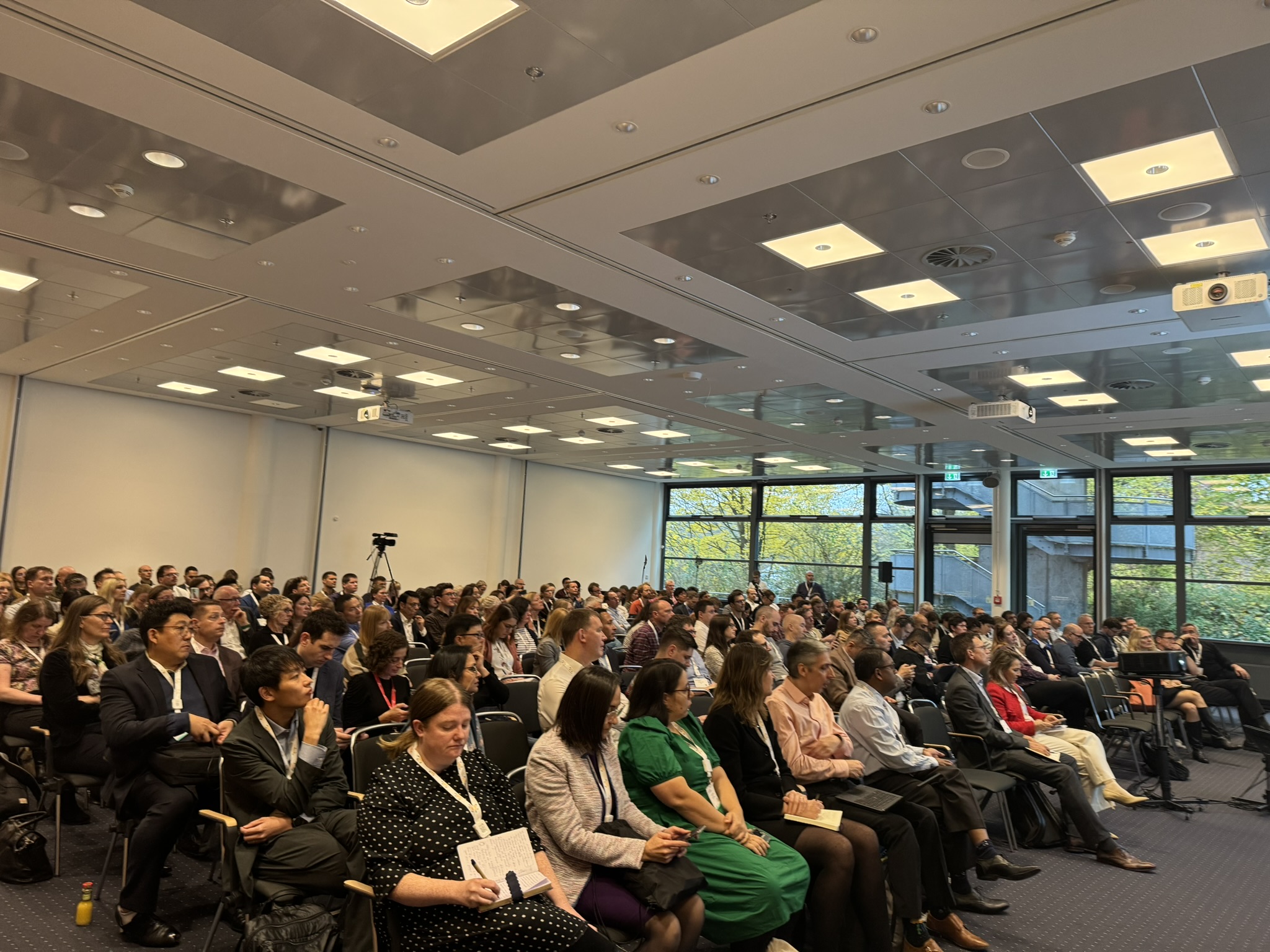 Front shot of a large audience sitting in a conference room