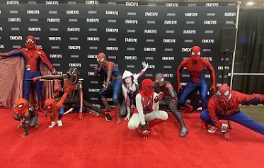 ten cosplayers dressed up in various versions of Spiderman