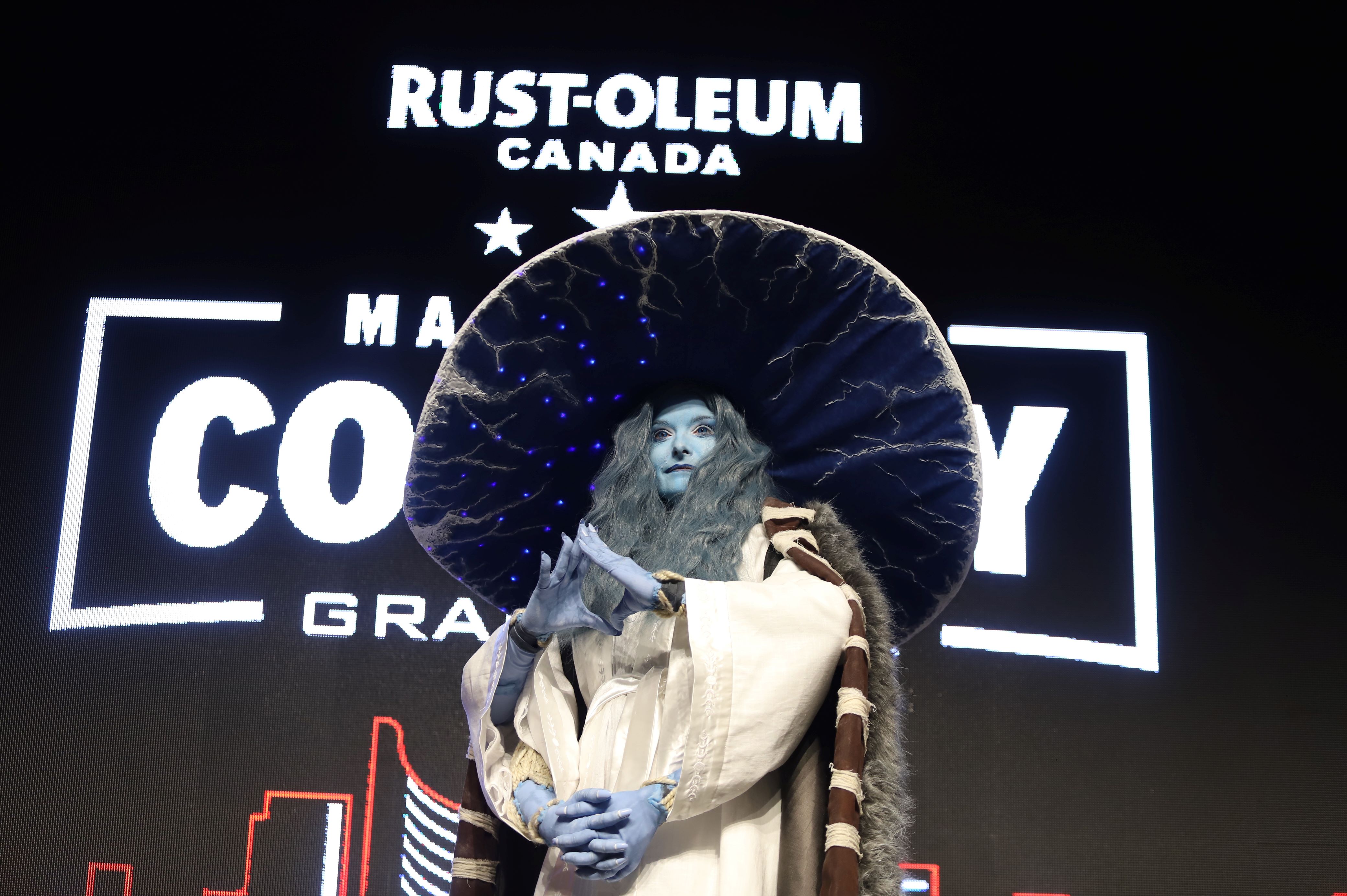 Cosplayer poses on stage during the cosplay grand prix