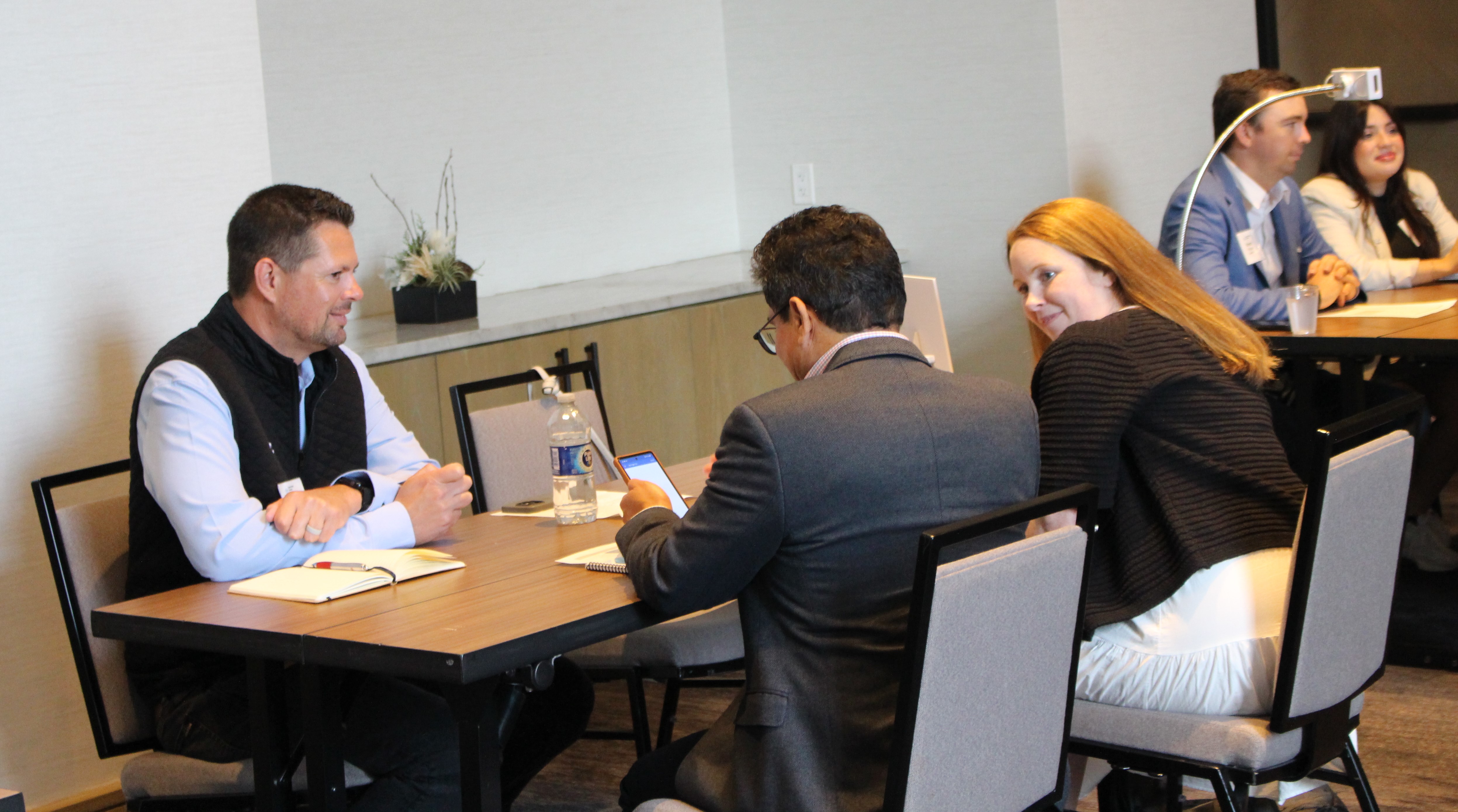 Attendees chatting at a table together