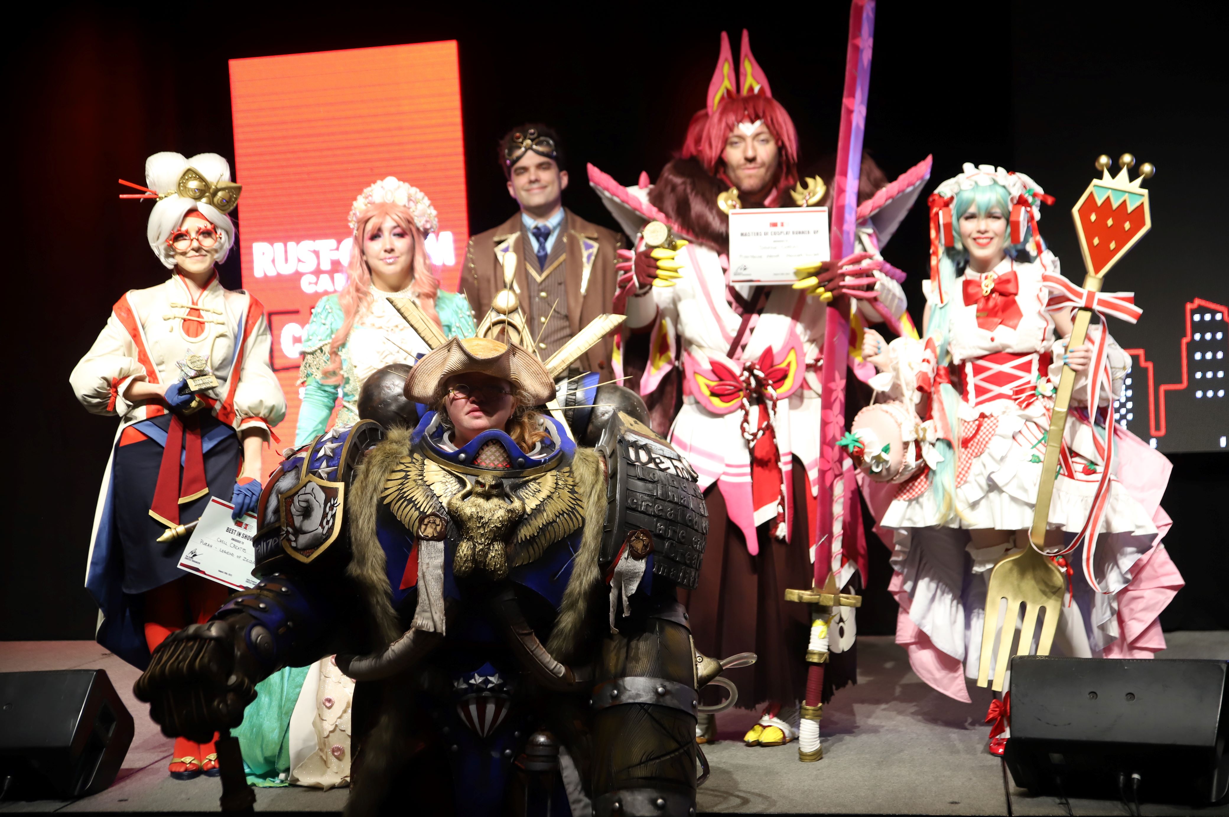 cosplay grand prix winners pose on stage