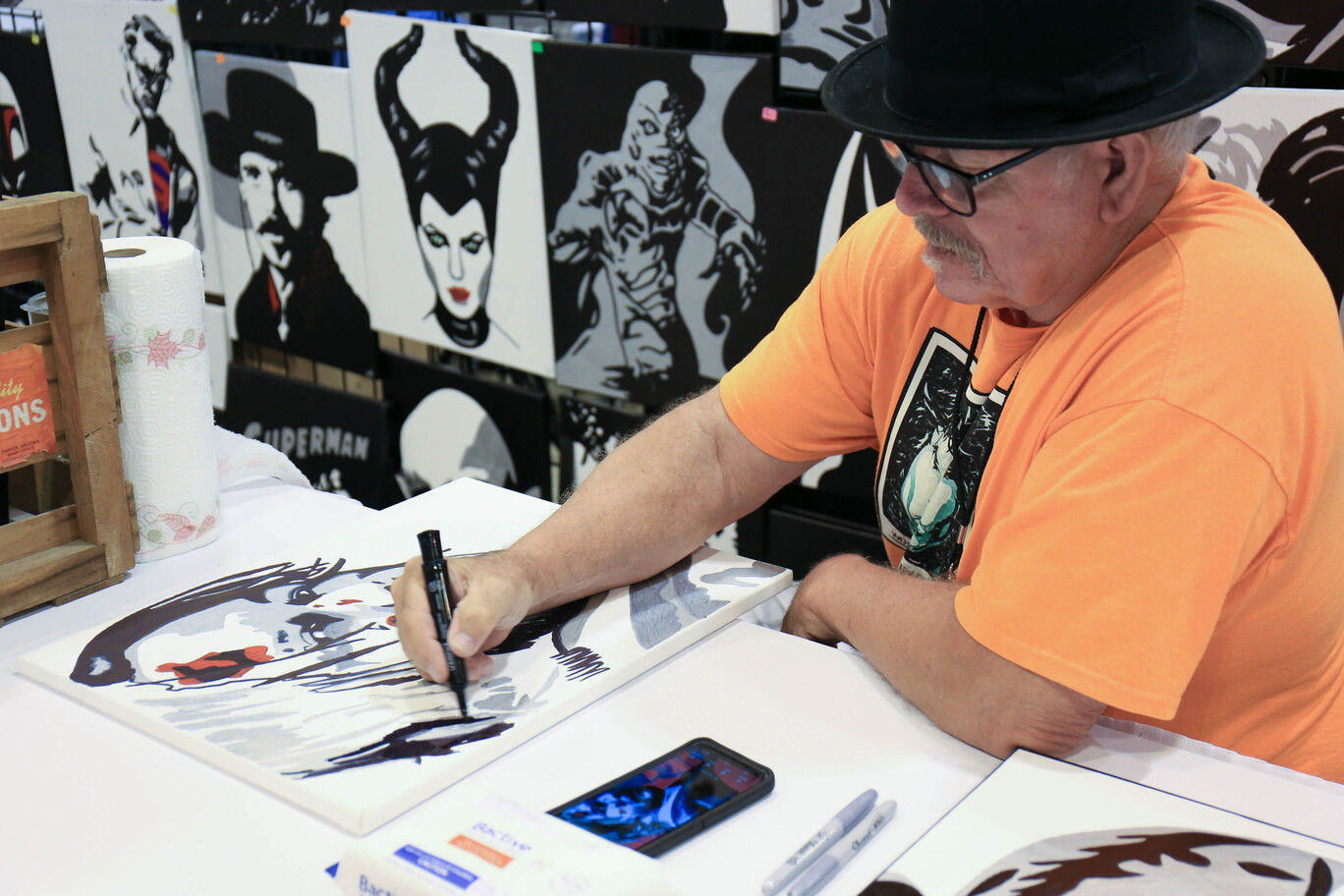 Artist drawing in artist alley at FAN EXPO St. Louis 2022