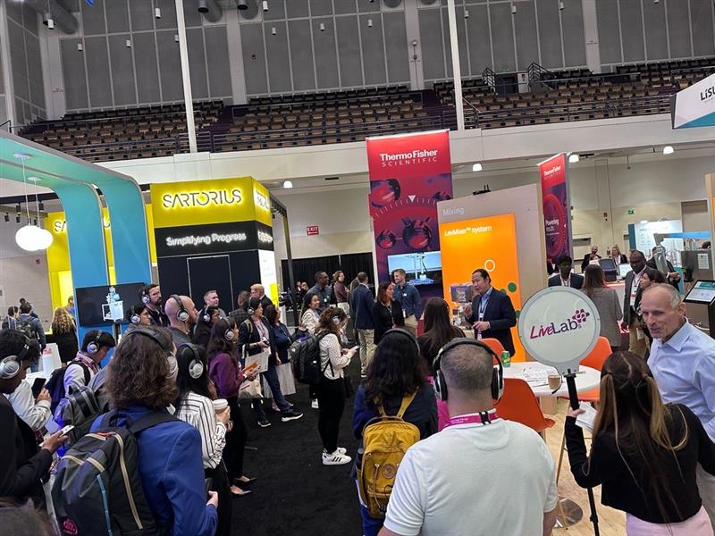Biopharma professionals attend a live lab demonstration in the exhibit hall at BioTech Week Boston.