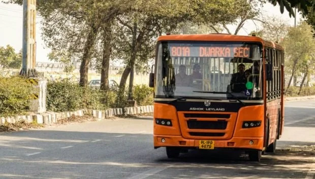 orange metro bus on the road in an India city