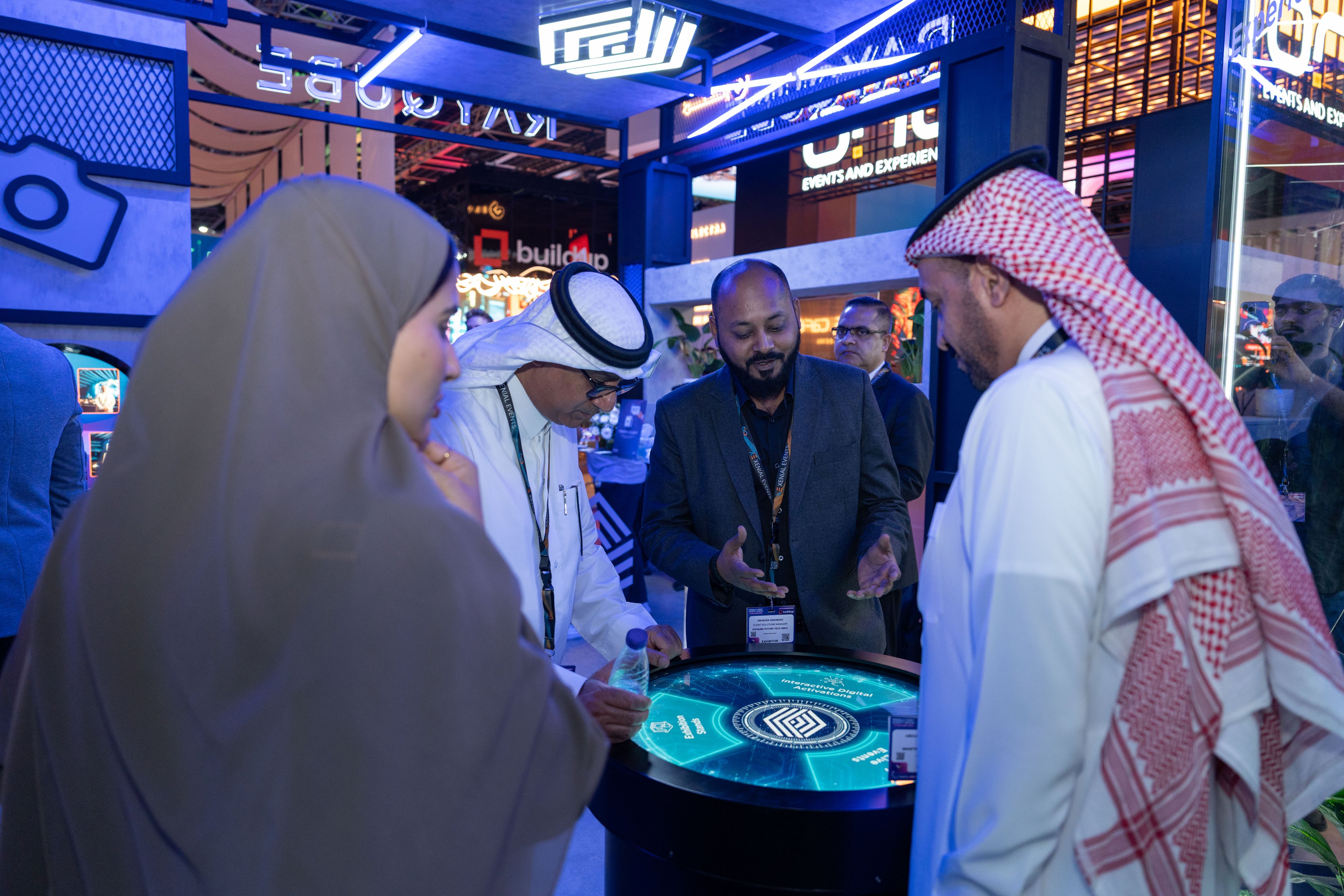 Exhibitors demonstrating interactive event technology to attendees at MEES, showcasing innovation at Dubai World Trade Centre.