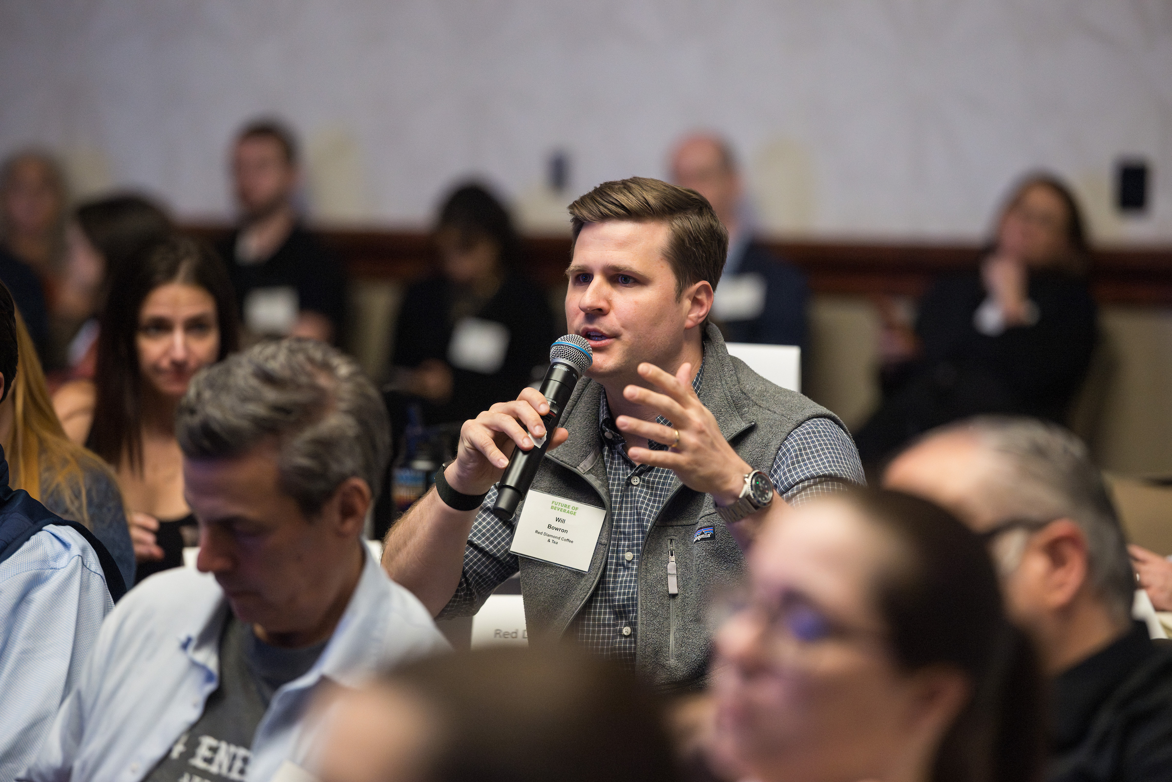 Attendee at Future of Beverage speaking in a microphone