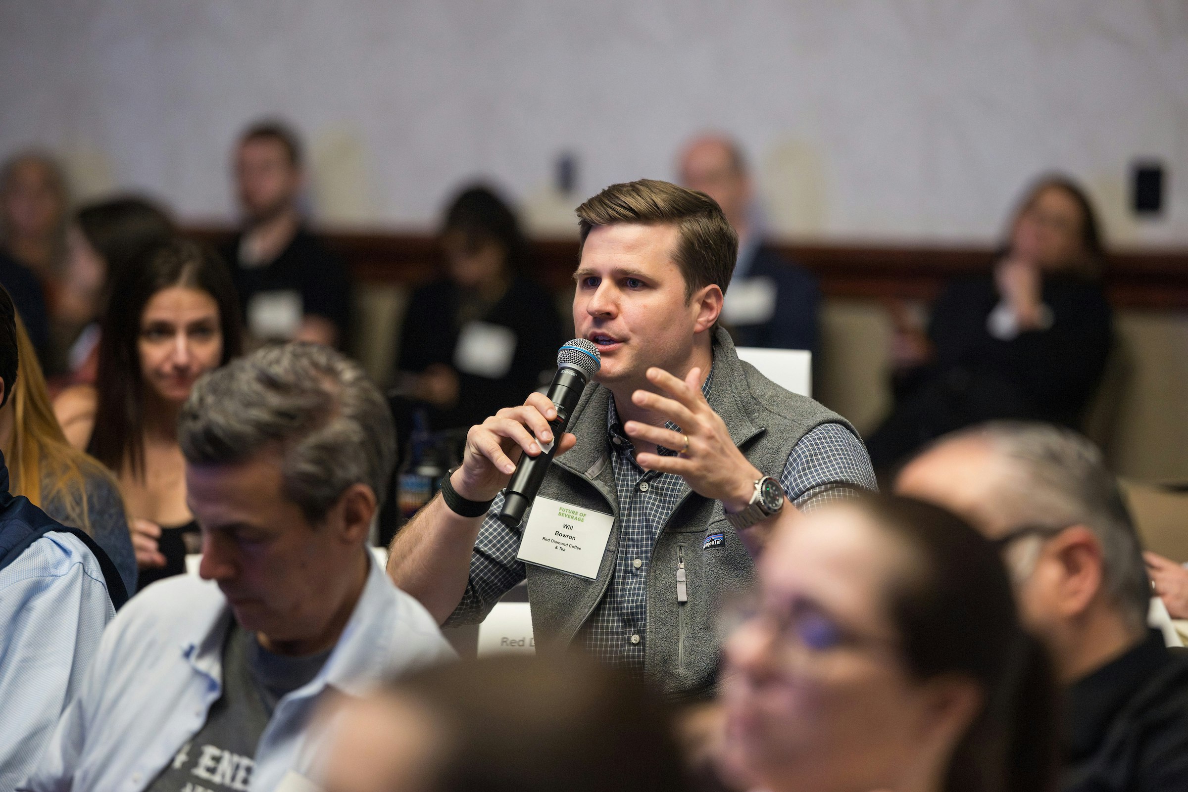Attendee at Future of Beverage speaking in a microphone