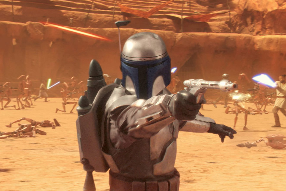 Jango Fett from Attack of the Clones fires a blaster at someone off screen