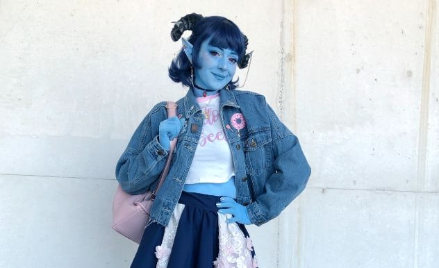 Ginny Di in blue face paint with a blue jean jacket & blue wig