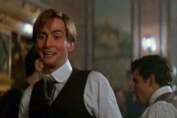 David Tennant in a white shirt and dark vest.