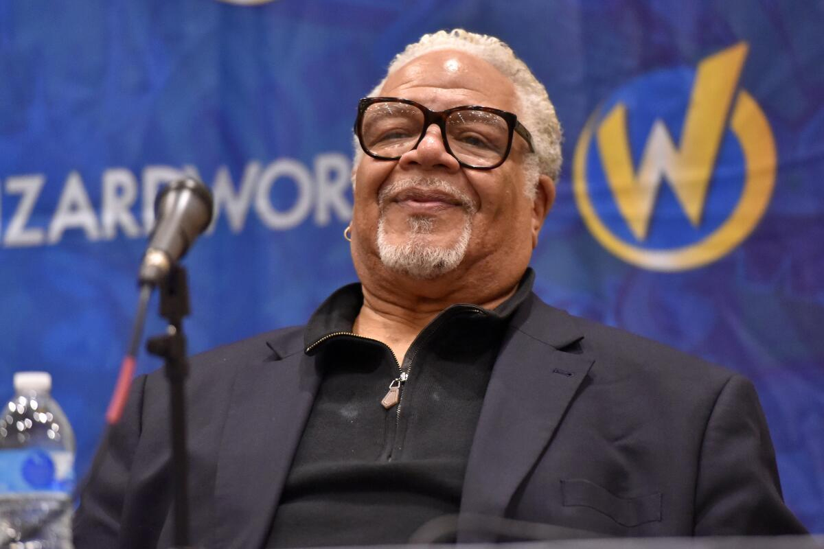 Tara Strong poses powerfully in a red leather jacket