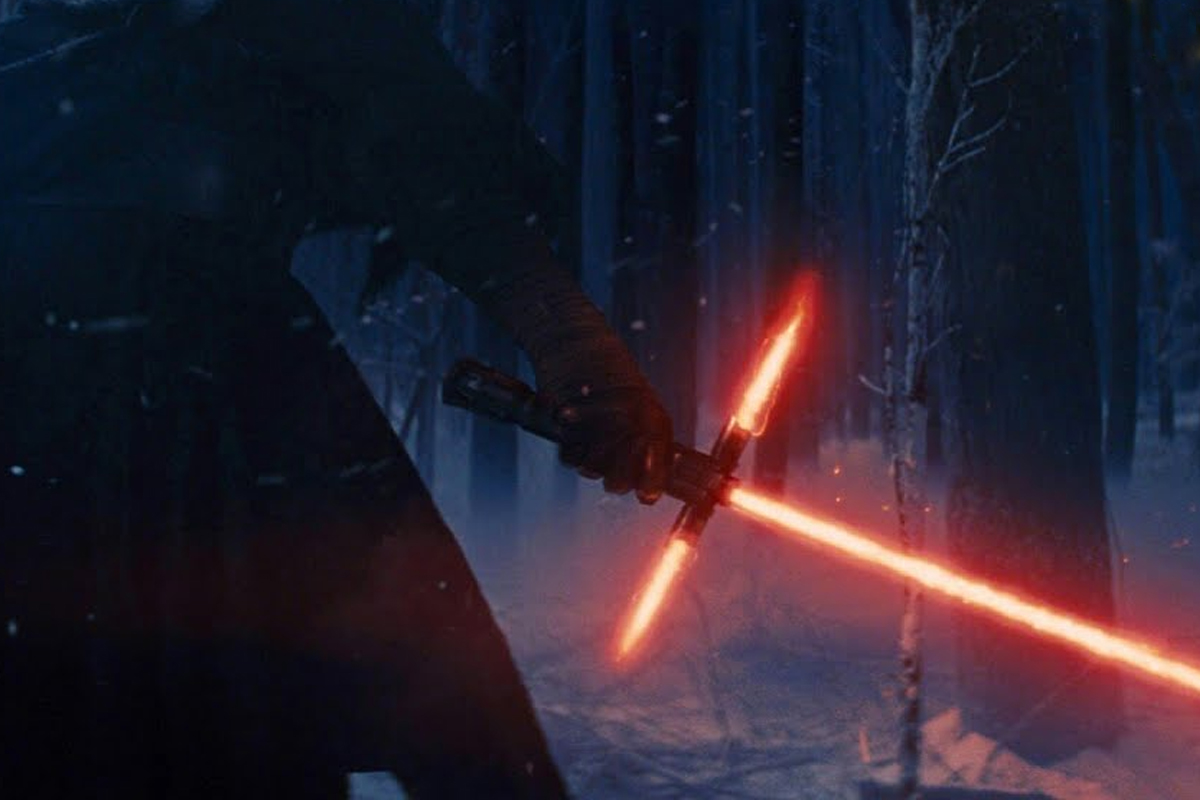 Kylo Ren's iconic cross guard lightsaber ignited with red/yellow beams coming out of it